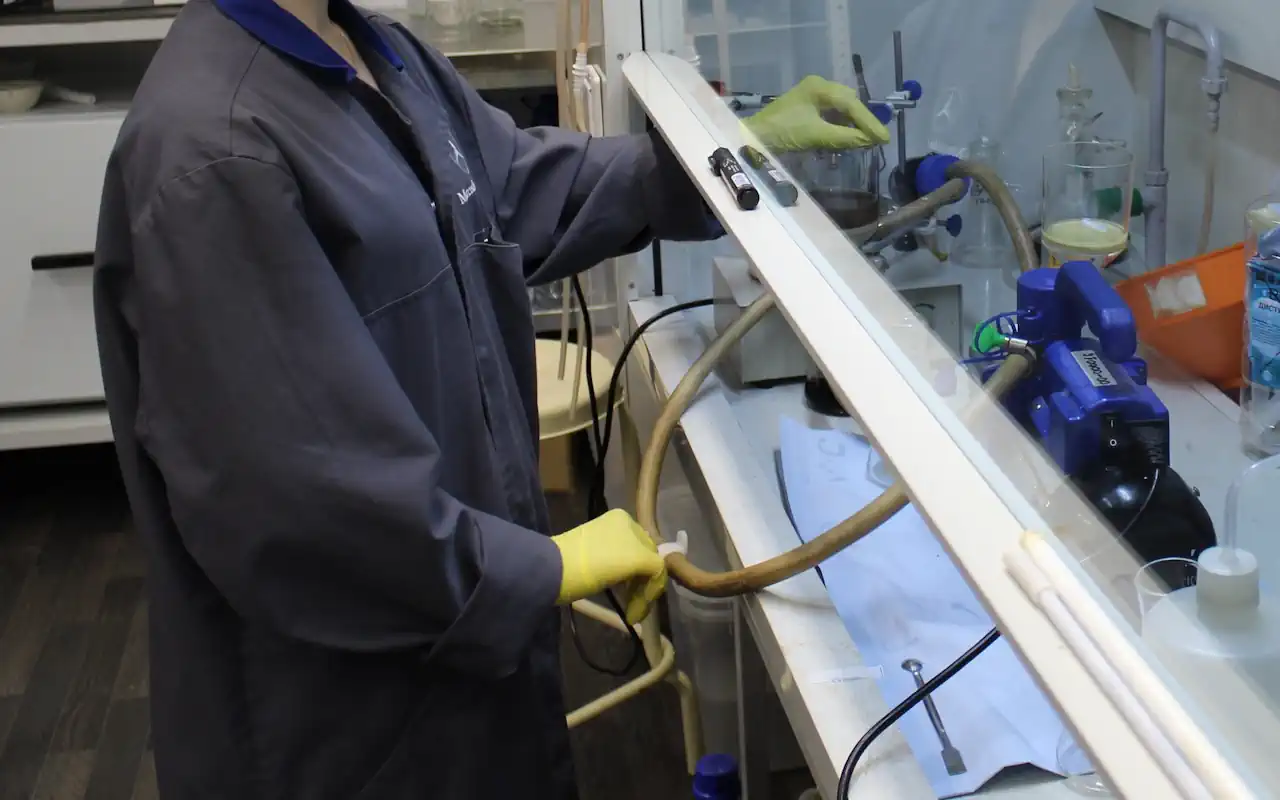 Lab technician working under a fume hood in the R&D center